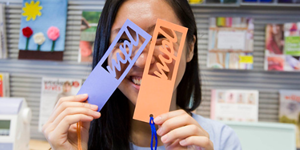 Girl holding MPL cutouts